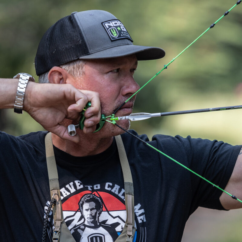 John Dudley of Nock On Archery at full draw looking through Peep Sight.