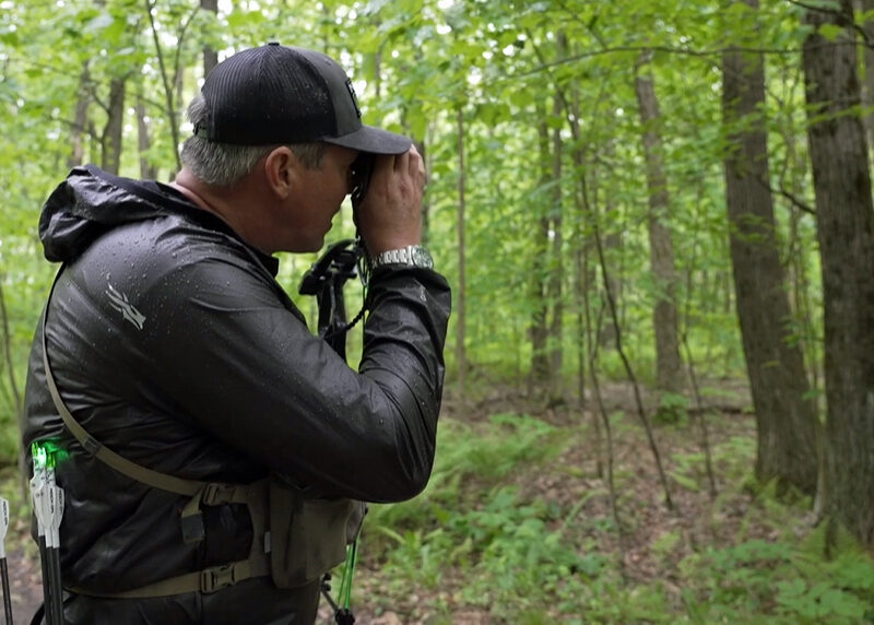 John Dudley of Nock On Archery using a Leupold Rangefinder in thick foliage on an archery course.