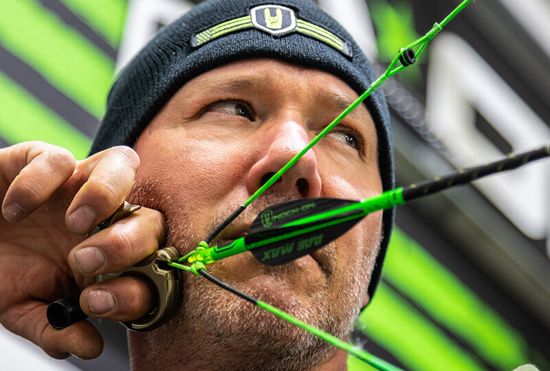 John Dudley looking through his peep sight on a compound bow.