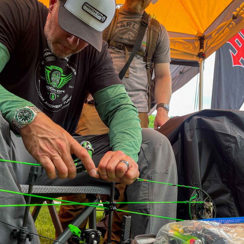John Dudley using an archery repair kit to repair a compound bow.