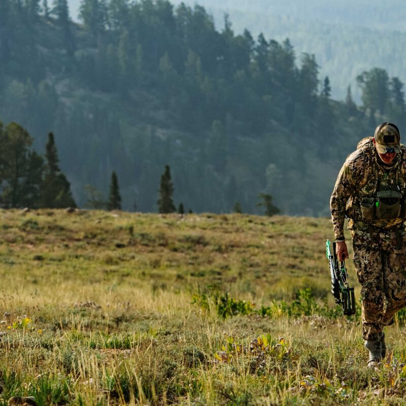 John Dudley hiking in the mountains during a bowhunting elk hunt.
