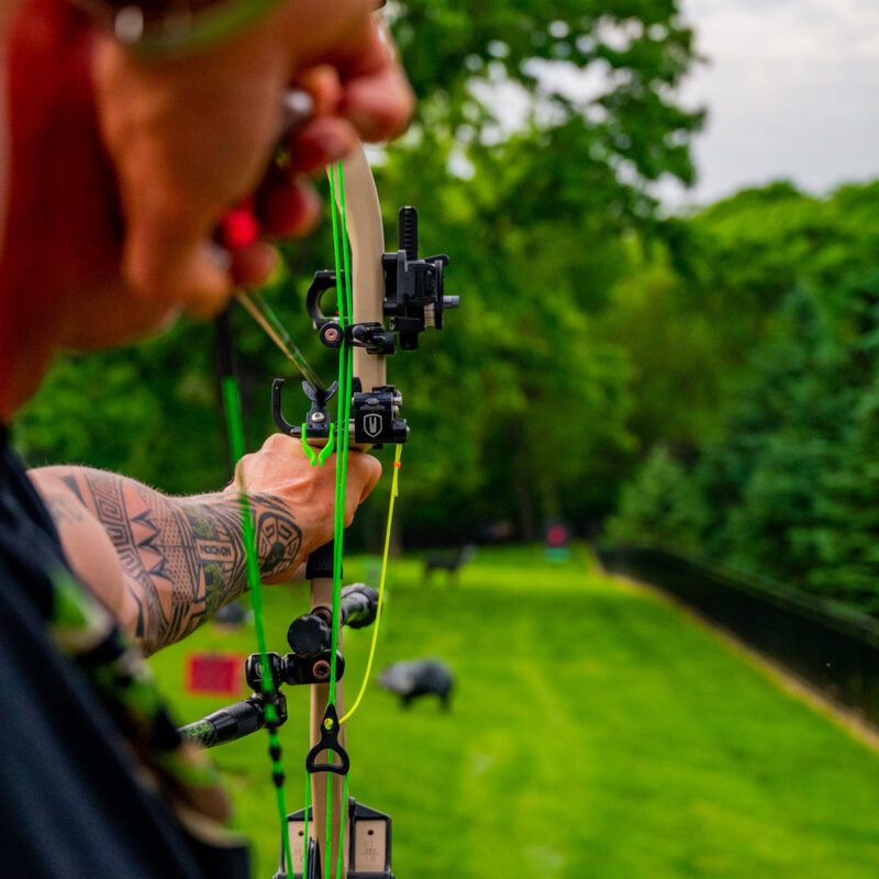 John Dudley of Nock On Archery shooting archery outdoors with specific sight pin configuration for outdoor archery.