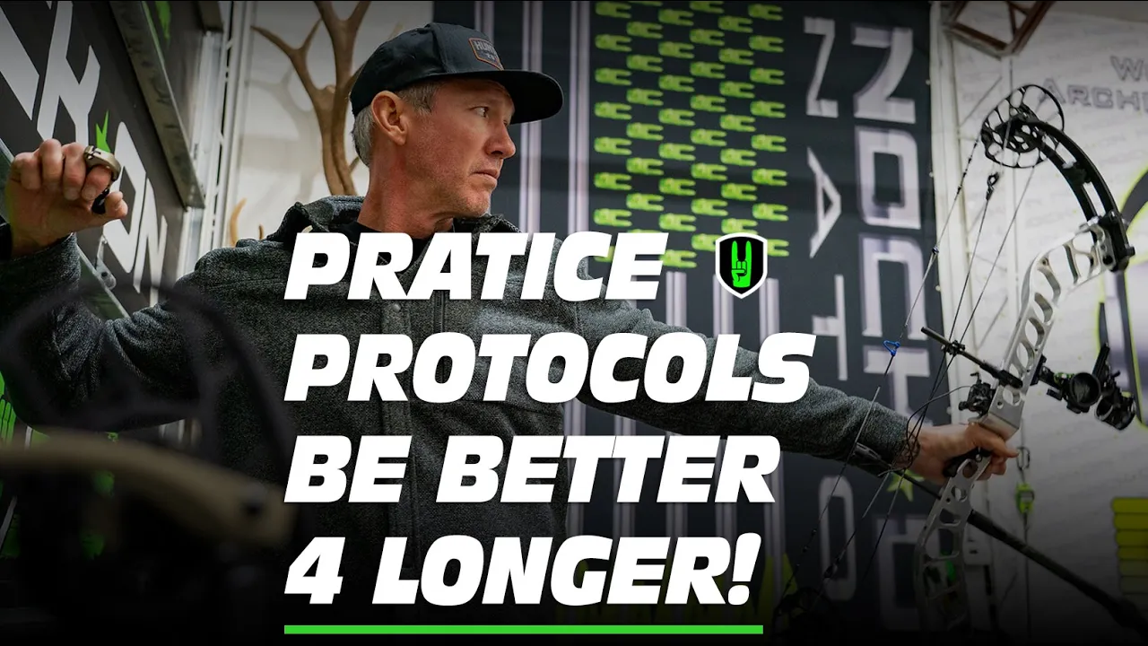 PRACTICE PROTOCOLS! Be BETTER, LONGER! 1 John Dudley drawing a compound bow in an indoor archery range, with the text ‘PRACTICE PROTOCOLS BE BETTER 4 LONGER!’ overlaid in bold white and green letters against a backdrop featuring archery-themed graphics.
