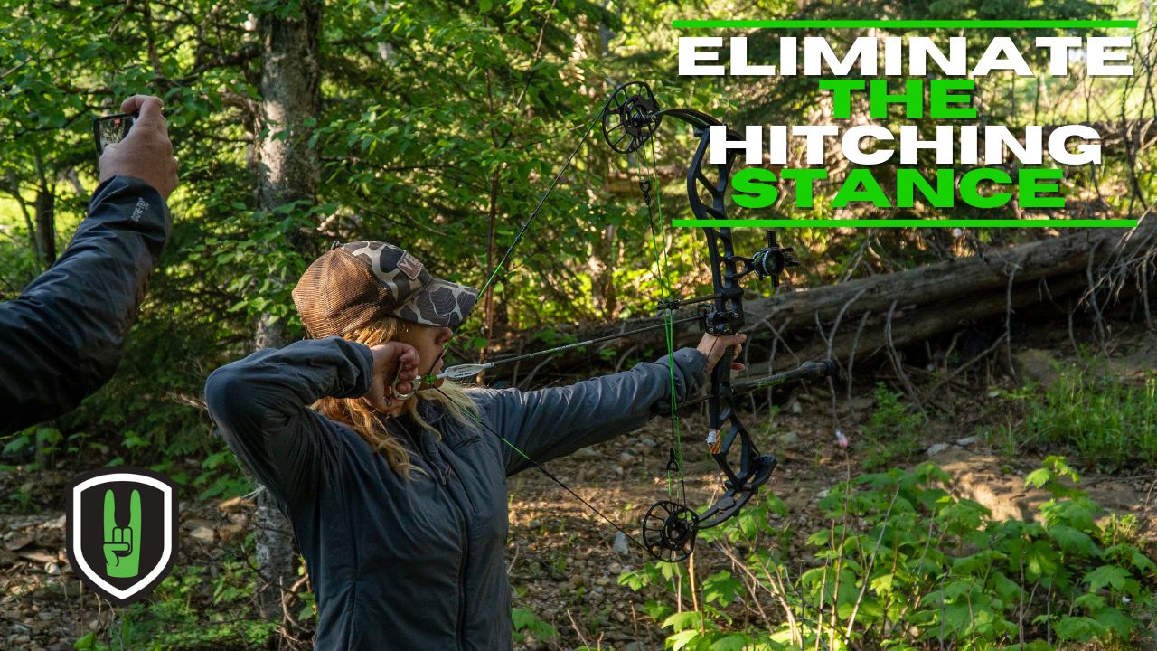 Eliminate the Hitching Stance - DON'T BE A BENT T! 1 Woman at full draw in the woods with a compound bow.