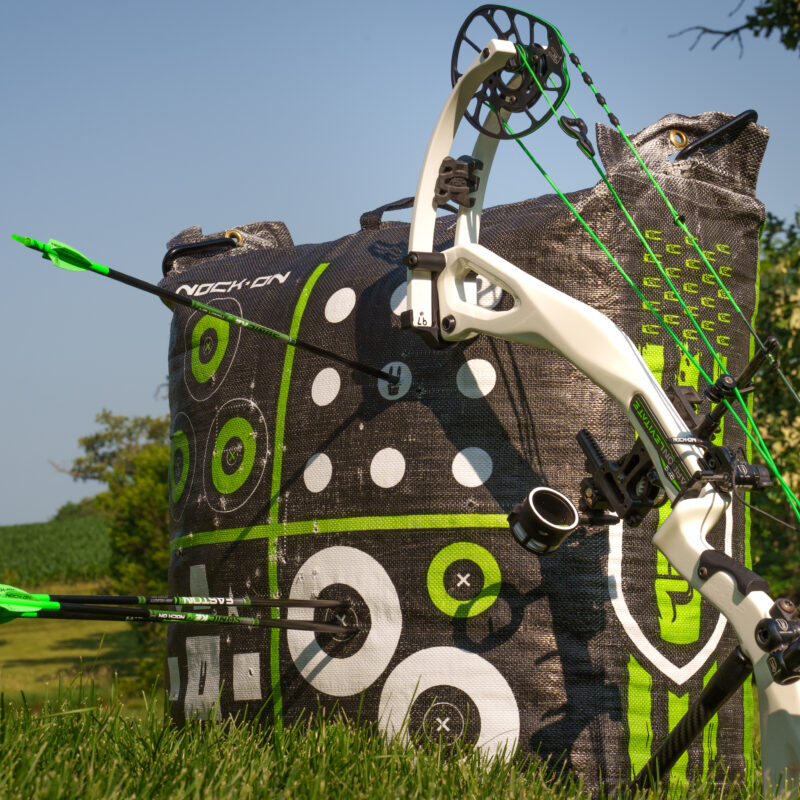 A close up of a Nock On target and compound bow.