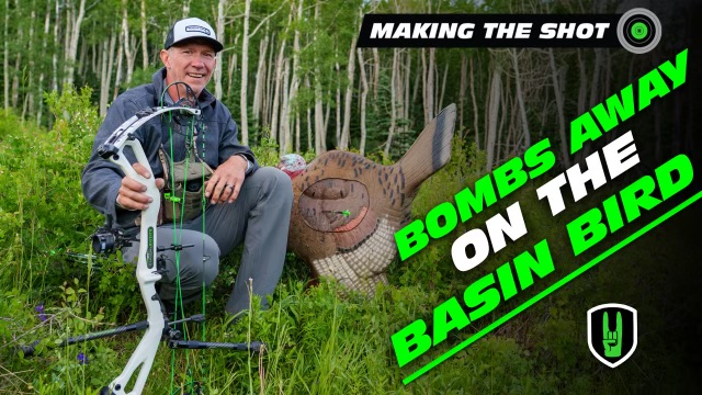 The Sloping Strutter! - Making the Shot 1 John Dudley with his compound bow sitting in the woods with a 3d turkey target.
