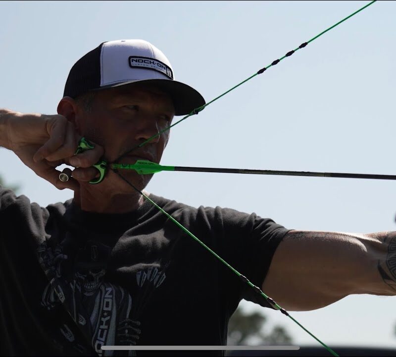 Close up of John Dudley at full draw.