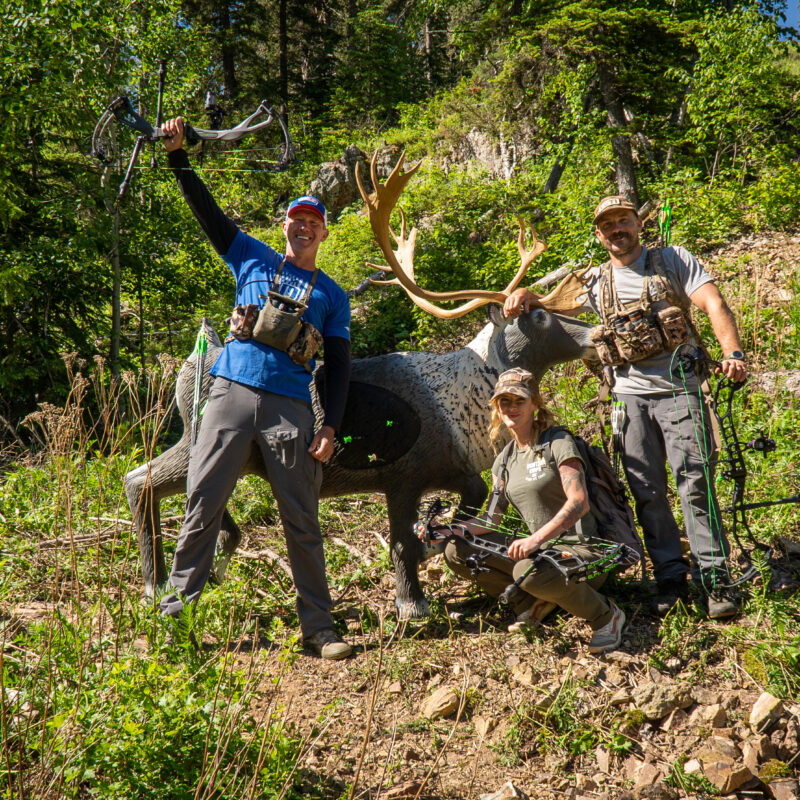 John Dudley and Mark Carter celebrating on a mountain side with a 3d target.