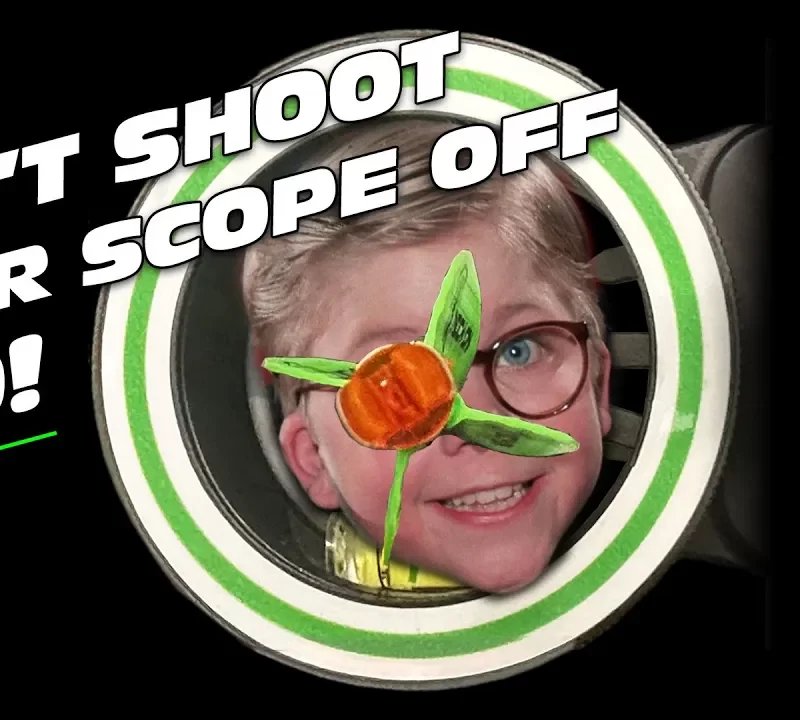 A close up of Ralphie from a Christmas Story in an archery scope with an arrow in his eye.
