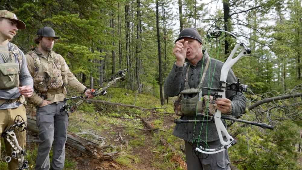 Mastering Uphill and Side-Hill Archery Shots: Conquering the Slope 1 Archer aiming uphill, peep sight centered, demonstrating the six-to-nine technique