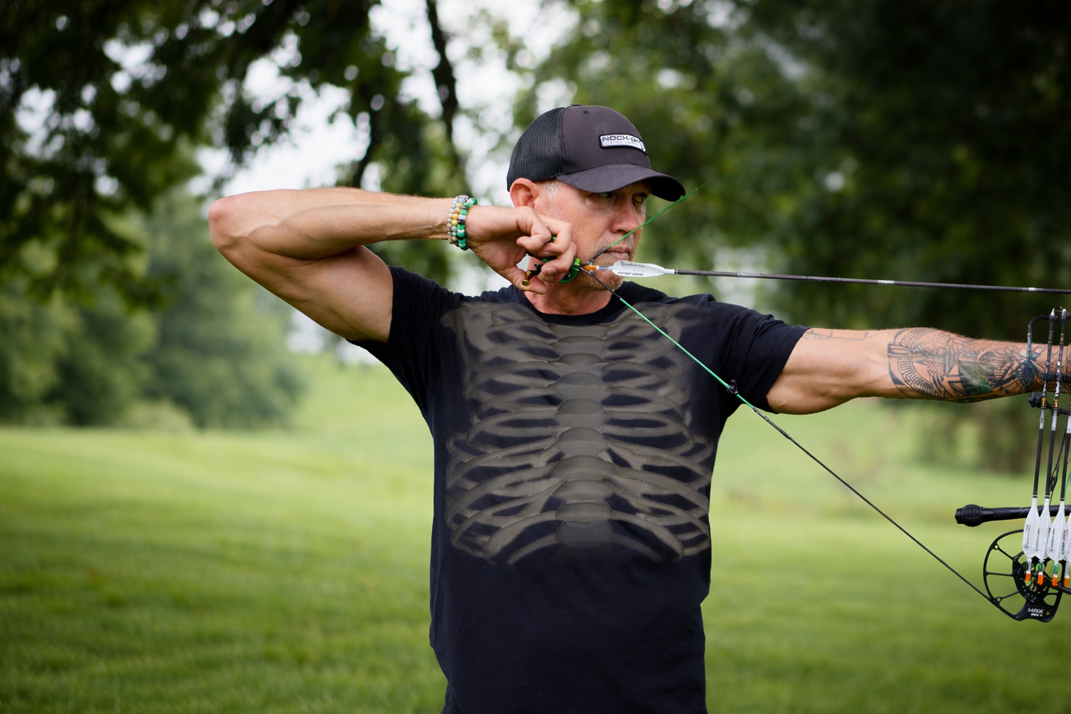 Archer at full draw with a compound bow.